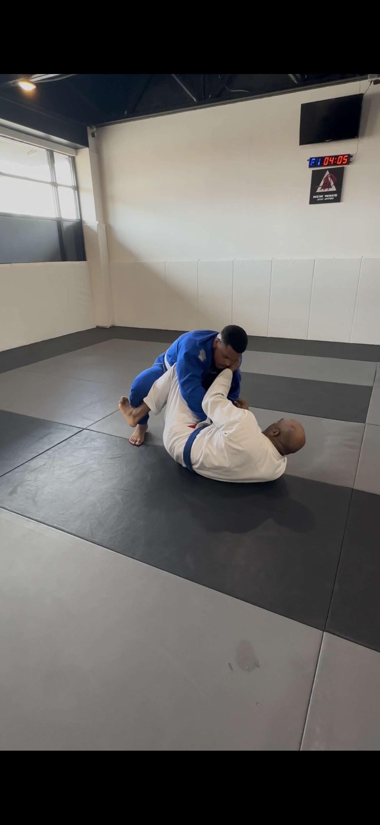 Partners working a grip in the gi