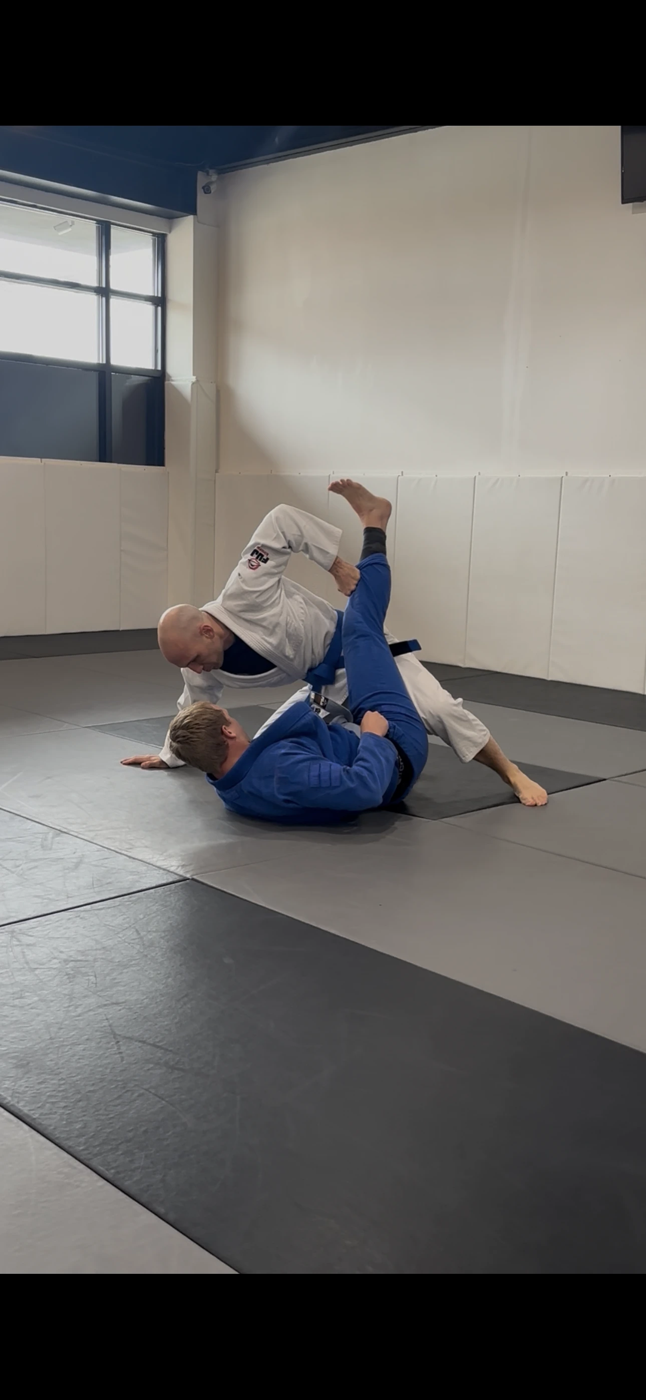 Adults drilling gi Jiu-Jitsu technique